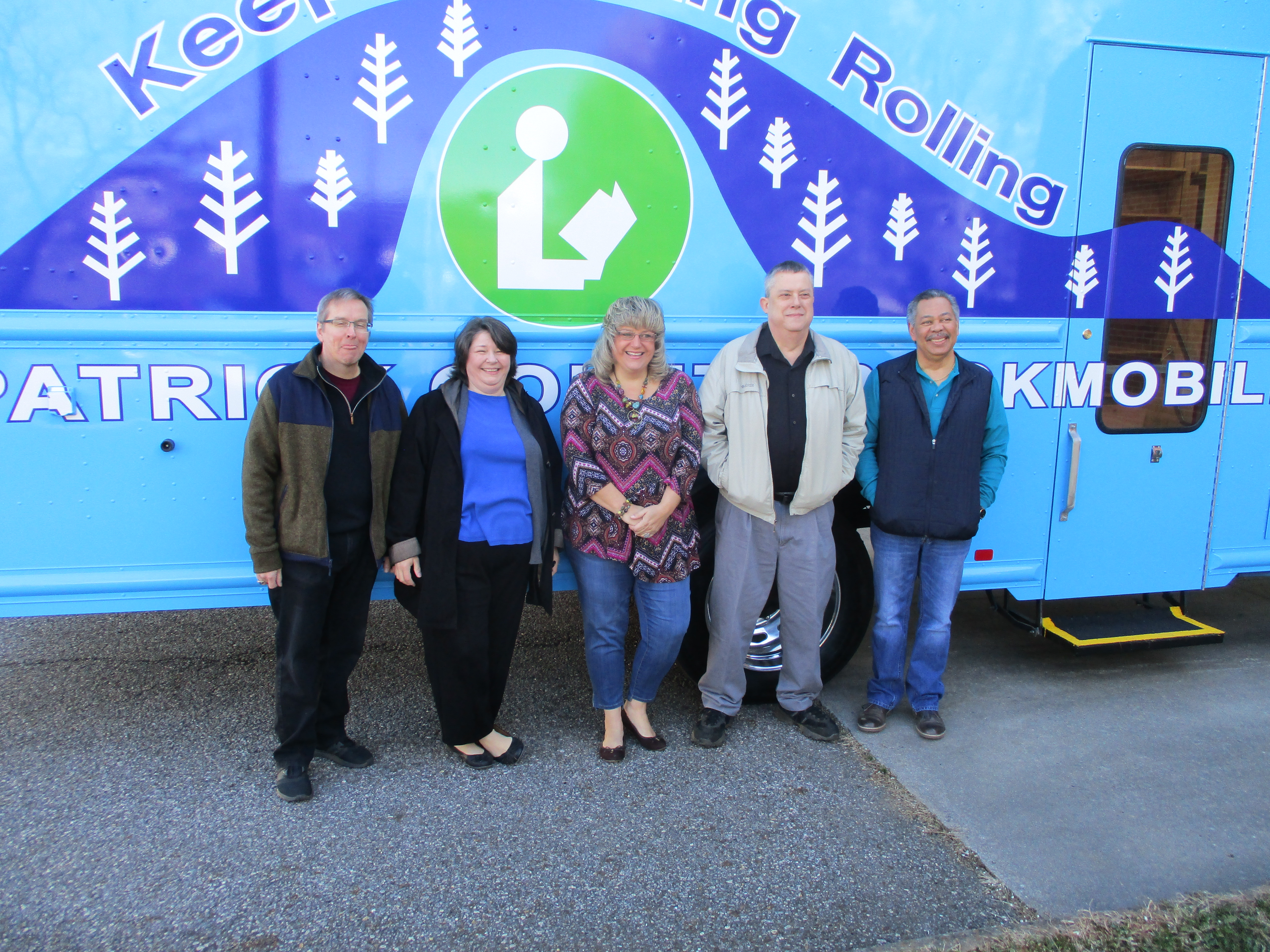 right side bookmobile with patrick county library staff, garry clifton branch manager, childrens librarian gayle wagoner, bookmobile driver, tammy cope, director of the system, rick ward, and assistant branch manager james martin